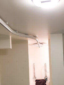Ceiling lift rail system into bathroom